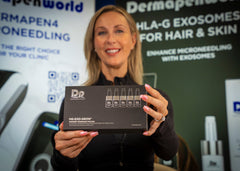 Load image into Gallery viewer, Woman holding a box labeled 'DP Dermapen' at an event with promotional banners in the background.