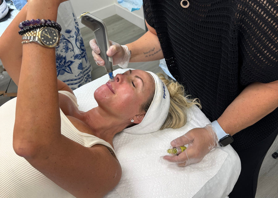 Woman getting a facial treatment with a professional in a spa setting.